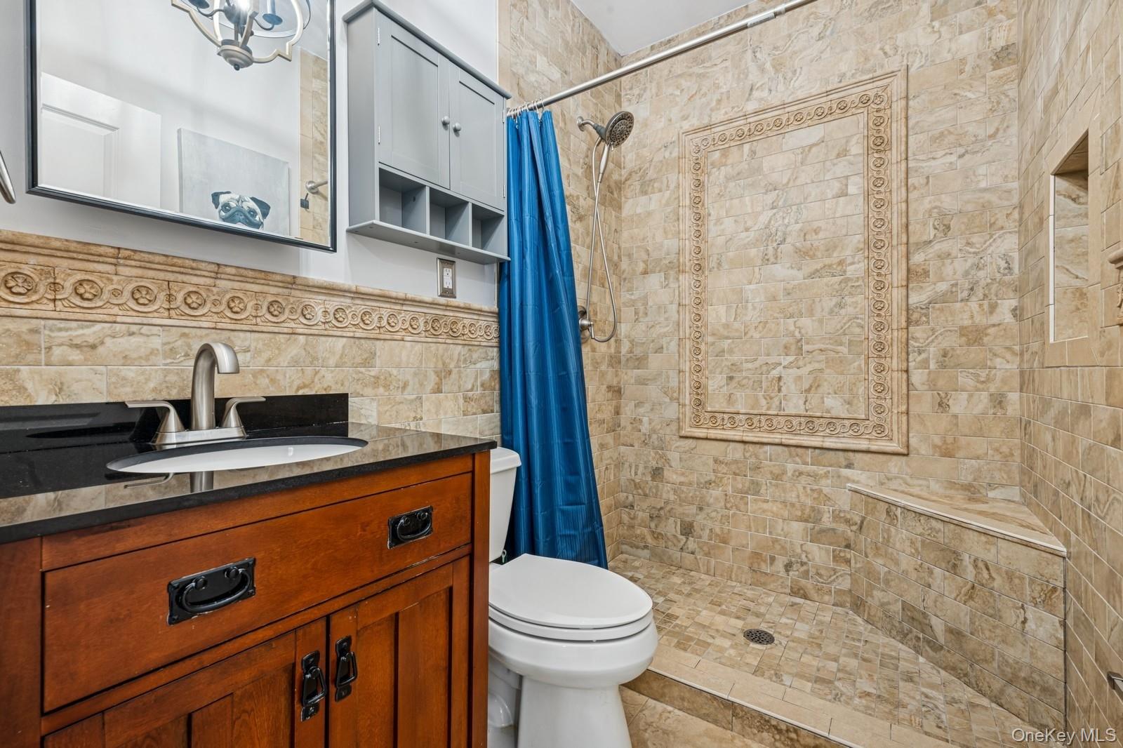 33 Bacon Road St. James, NY 11780 - Photo 40 of 48 a bathroom with a sink a toilet and shower