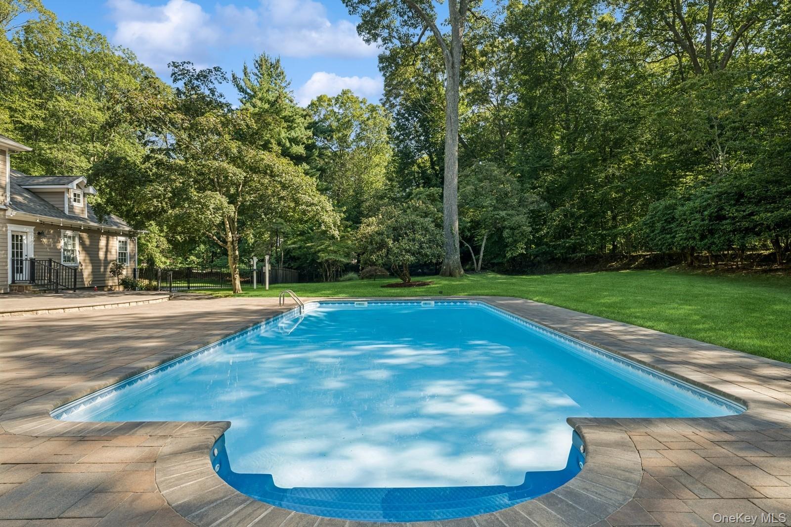 33 Bacon Road St. James, NY 11780 - Photo 42 of 48 a view of a swimming pool with a yard