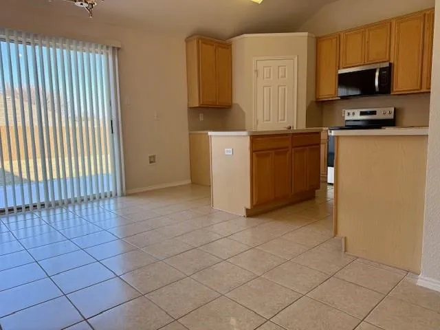 a kitchen with a sink a stove and cabinets