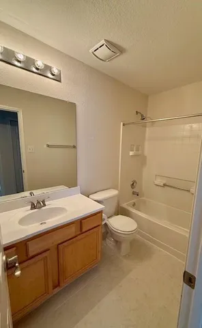 a bathroom with a double vanity sink toilet and shower