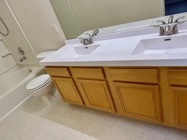 a bathroom with a sink a toilet and vanity