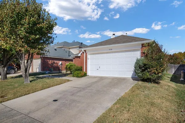 a view of a house with a yard and garage