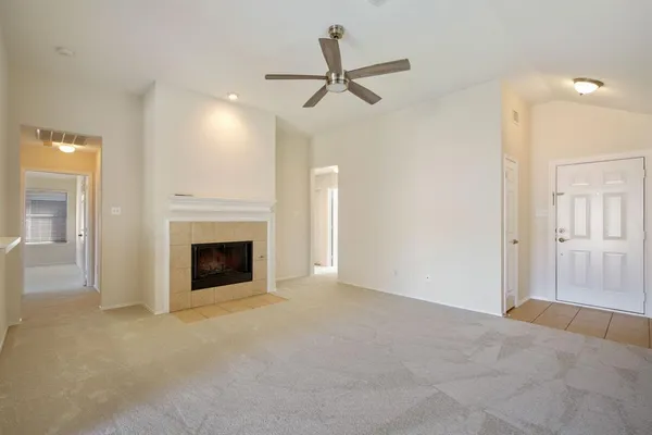 a view of a livingroom with a fireplace and a ceiling fan