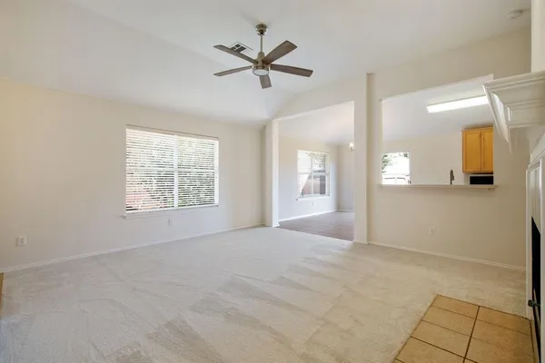 a view of a livingroom with a ceiling fan and window