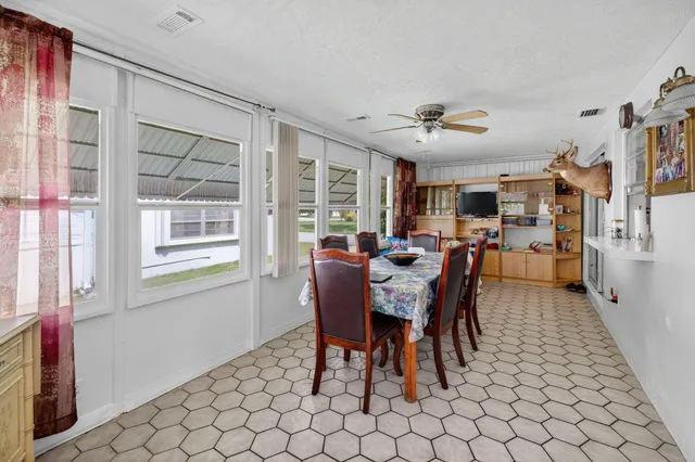 a dining room with furniture and window