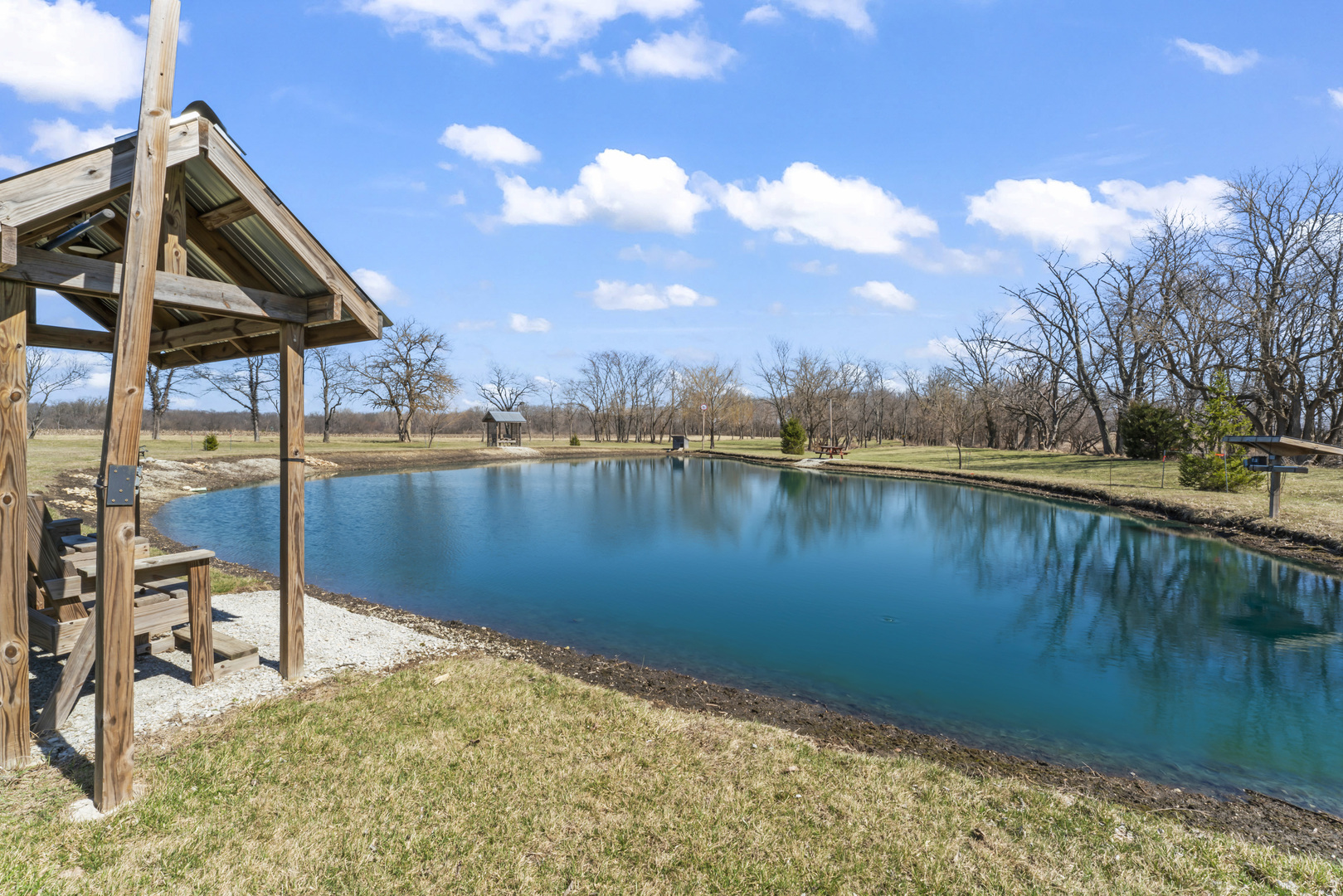 3015 North 1600 East Road Clifton, IL 60927 - Photo 33 of 46 a view of a lake with a house in the background