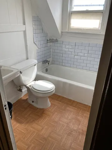 a bathroom with a toilet and a bathtub