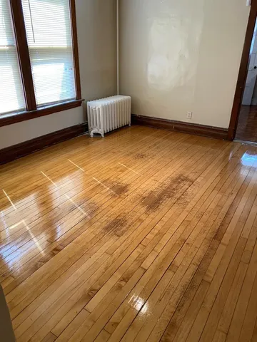 a view of a room with wooden floor and chair