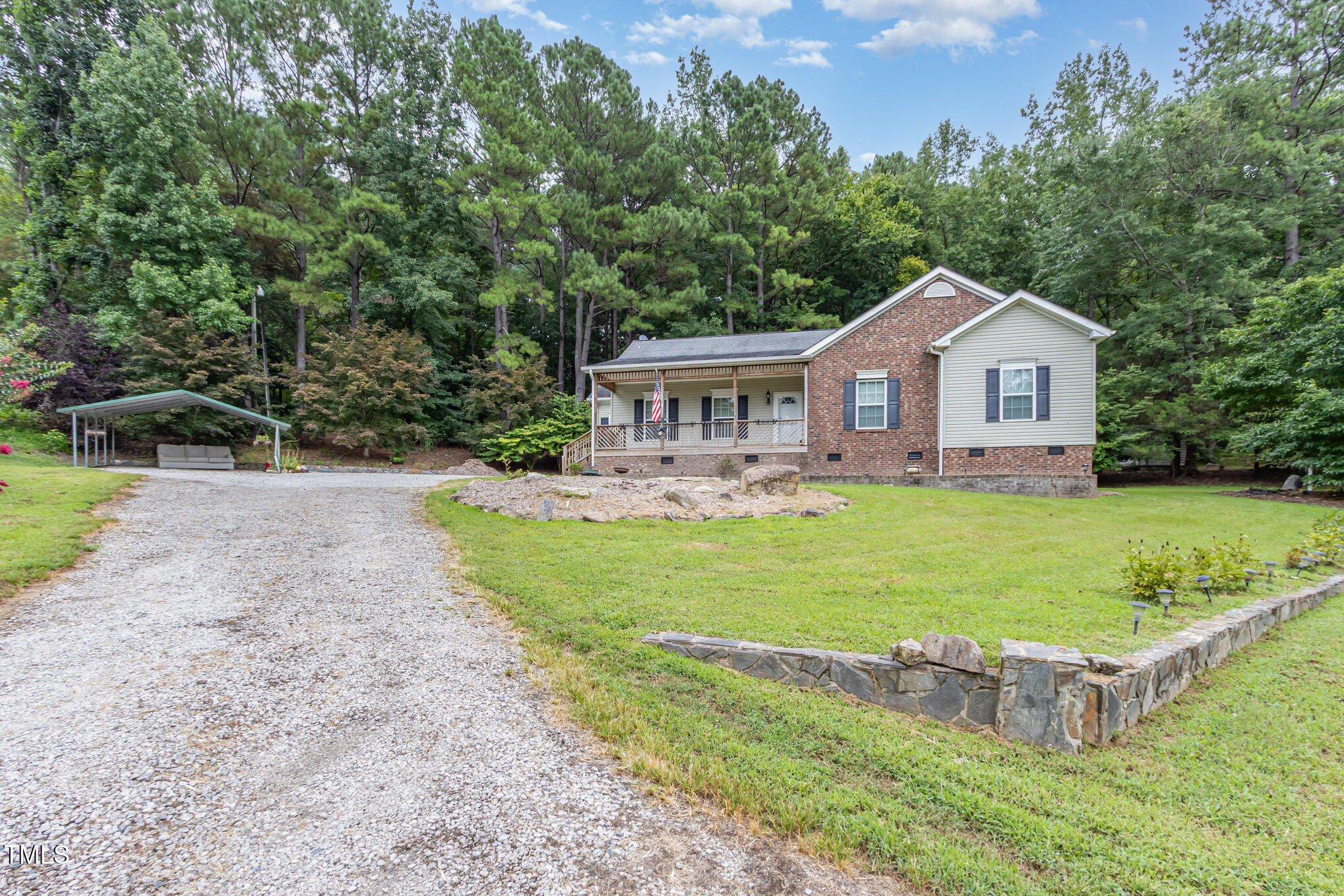 a front view of a house with garden and swimming pool