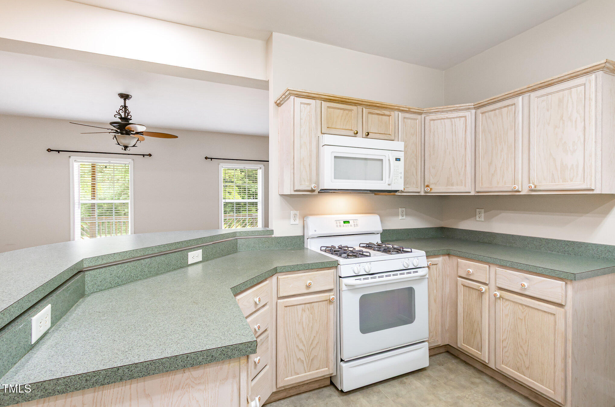 824 Kittrell Road Kittrell, NC 27544 - Photo 16 of 37 a kitchen with white cabinets and white appliances