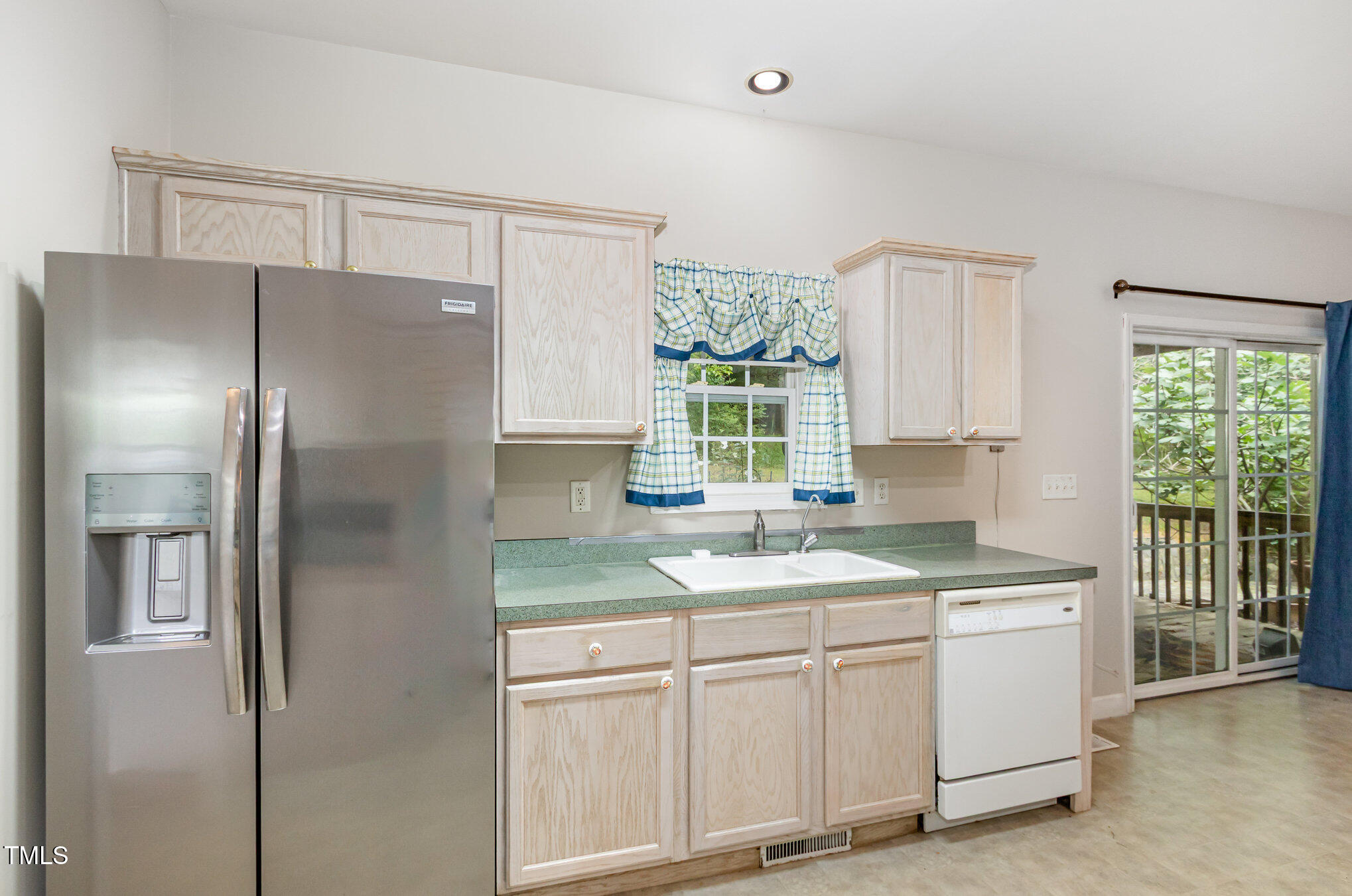 824 Kittrell Road Kittrell, NC 27544 - Photo 18 of 37 a kitchen with a refrigerator a sink cabinets and wooden floor