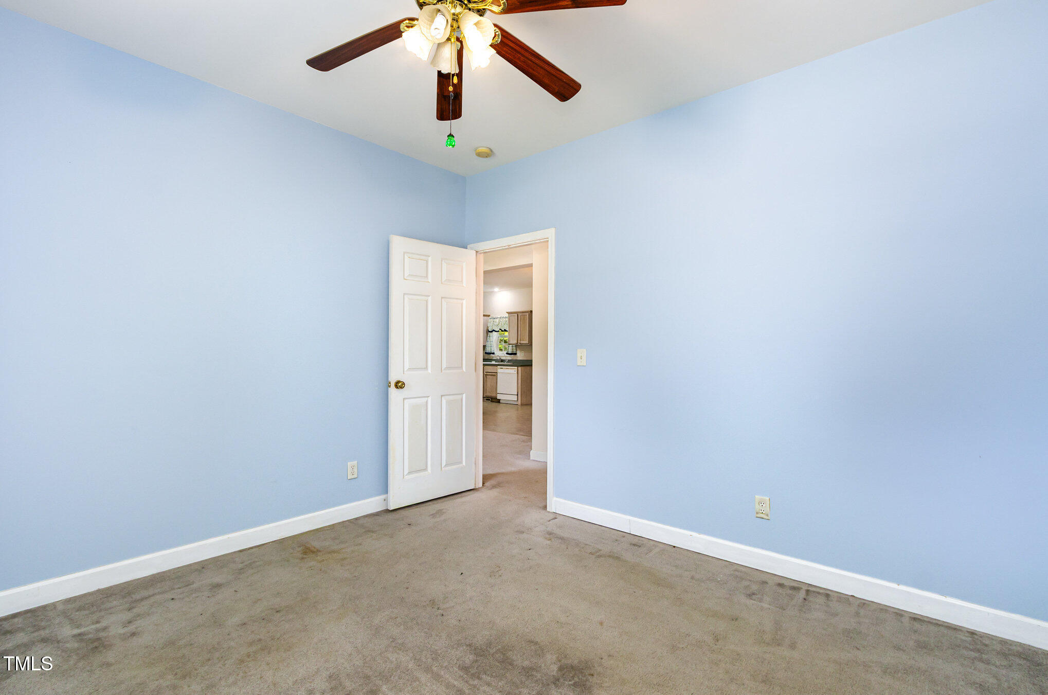 824 Kittrell Road Kittrell, NC 27544 - Photo 22 of 37 an empty room with a ceiling fan and carpet