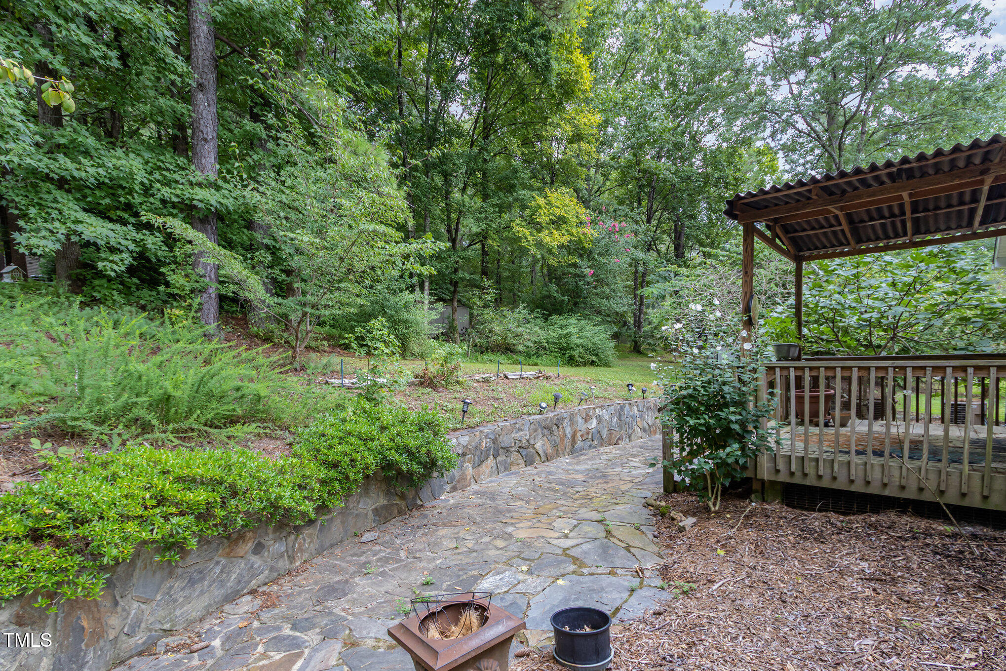 824 Kittrell Road Kittrell, NC 27544 - Photo 33 of 37 a view of a yard with large trees and wooden fence