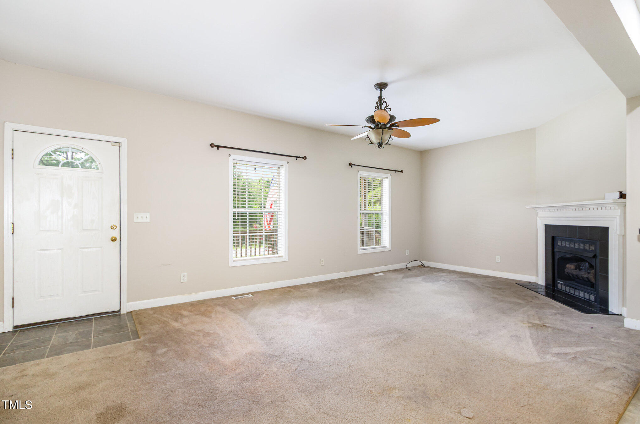 824 Kittrell Road Kittrell, NC 27544 - Photo 7 of 37 an empty room with windows and a ceiling fan