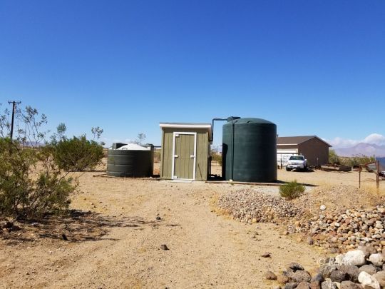 1165 Cory Street Ridgecrest, CA 93555 - Photo 23 of 26 a tall building with a yard