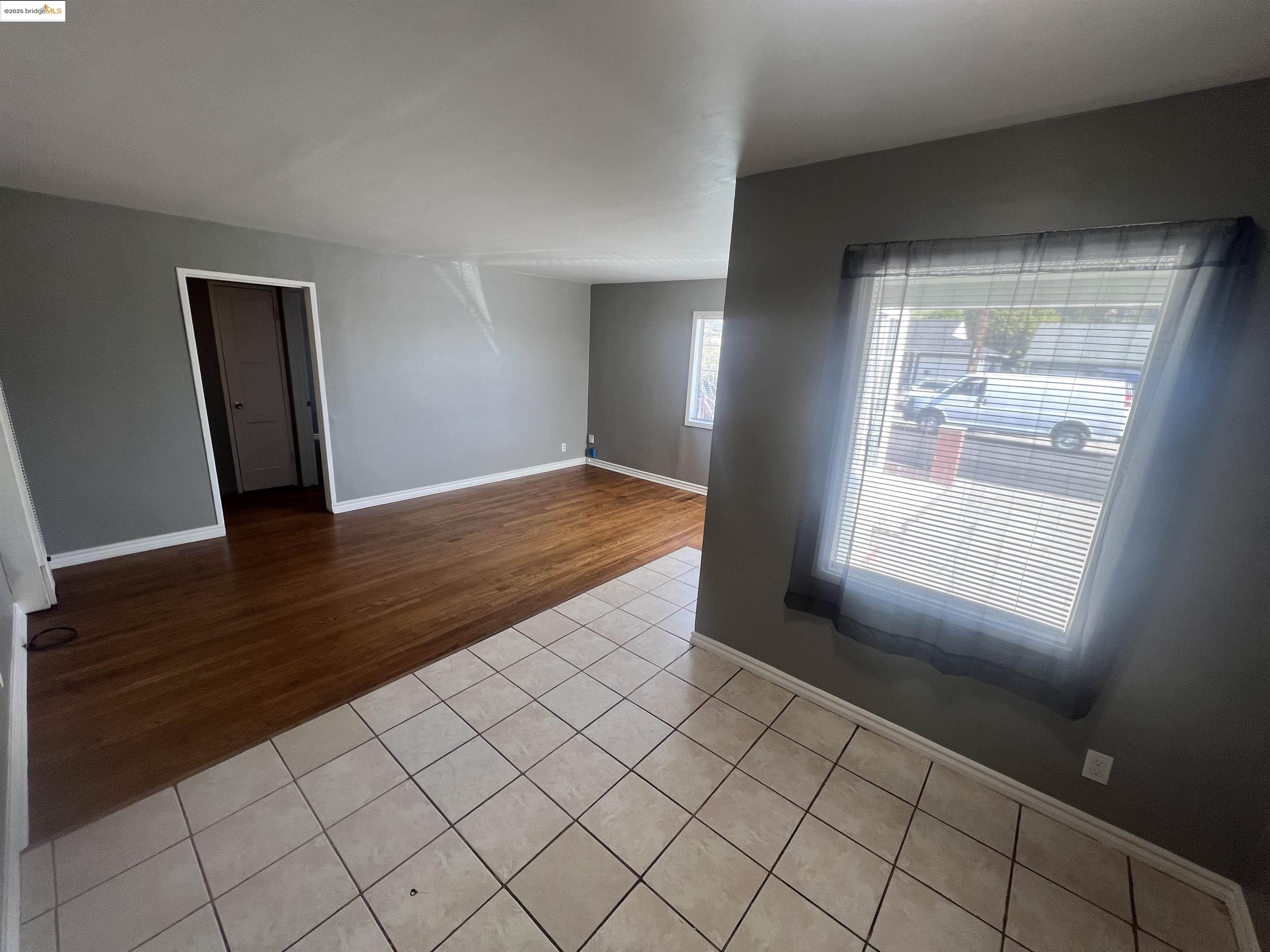2923 Devon Way San Pablo, CA 94806 - Photo 3 of 11 an empty room with wooden floor and windows