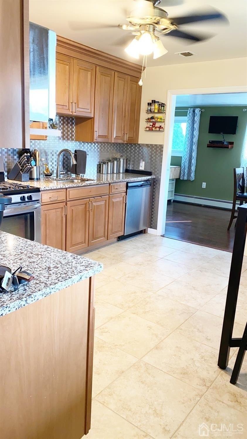 28 Baxter Road Edison, NJ 08817 - Photo 5 of 18 a kitchen with granite countertop a sink a counter top space and cabinets