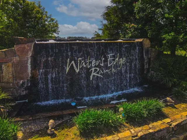 an aerial view of a house with a swimming pool