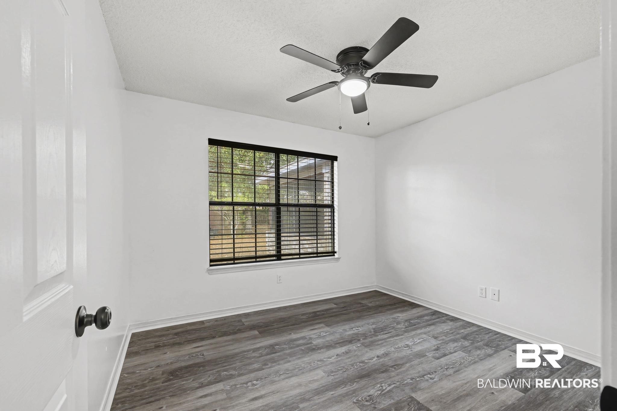 2776 Santa Rosa Circle Lillian, AL 36549 - Photo 24 of 48 Empty room with wood finished floors, a ceiling fan, and a textured ceiling