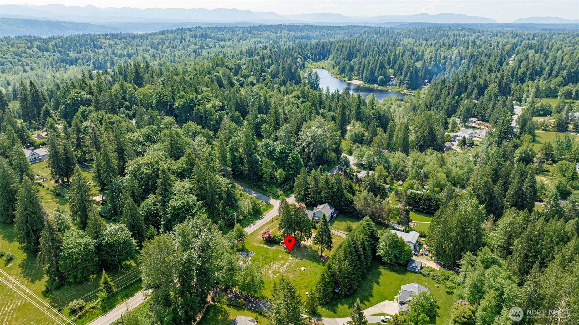 21022 Welch Road Snohomish, WA 98296 - Photo 24 of 28 a view of a lush green forest with trees and some houses