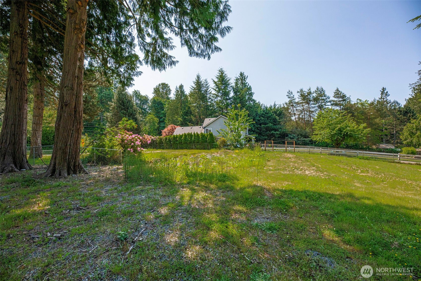 21022 Welch Road Snohomish, WA 98296 - Photo 9 of 28 a view of a garden with a bench