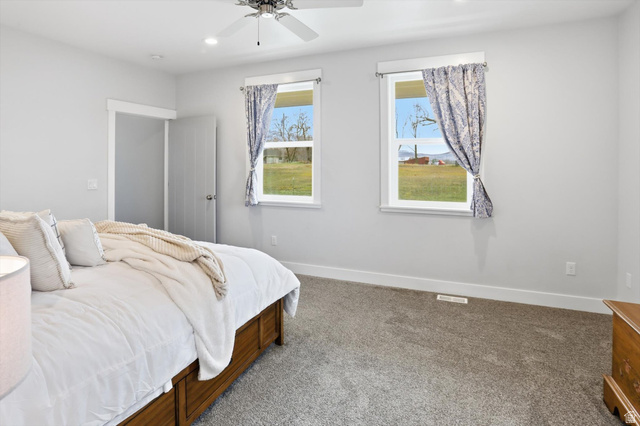 1009 High Creek Road Cove, UT 84320 - Photo 29 of 79 Main Floor Primary Bedroom with carpet floors, ceiling fan, and recessed lighting