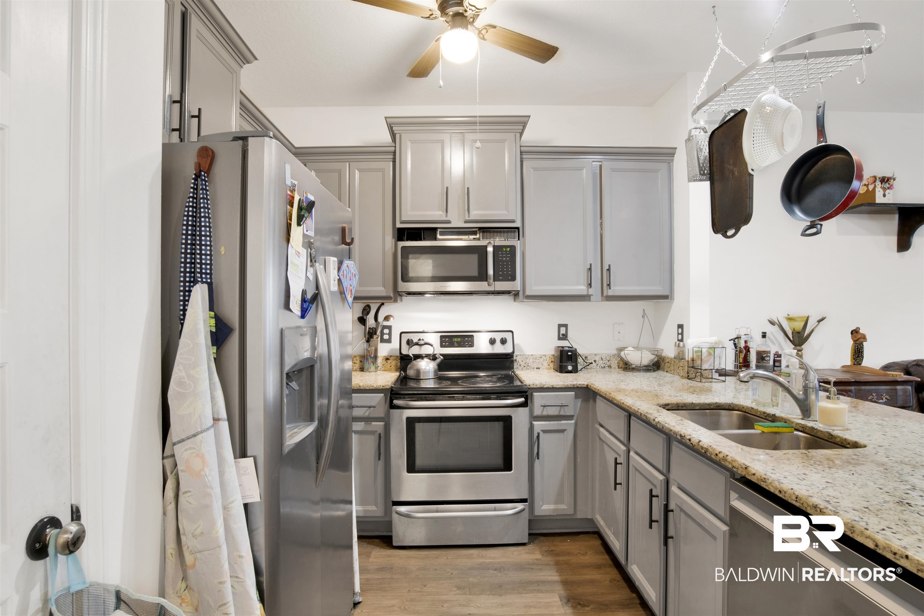25806 Pollard Road, Unit 80 Daphne, AL 36526 - Photo 13 of 30 Kitchen with gray cabinetry, stainless steel appliances, light stone countertops, a ceiling fan, and light wood-style floors