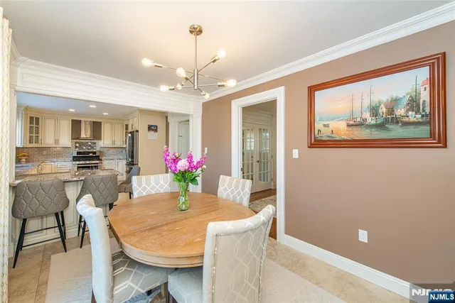 a view of a dining room with furniture and a chandelier