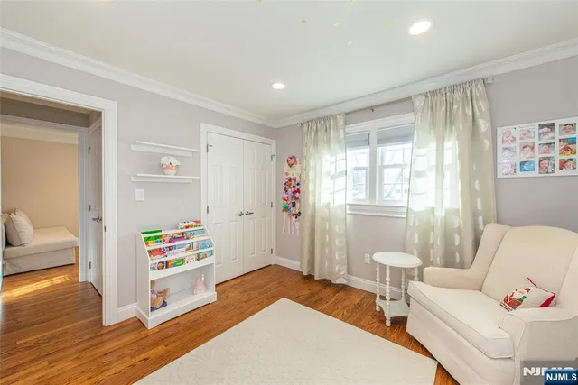 a bedroom with furniture and a wooden floor