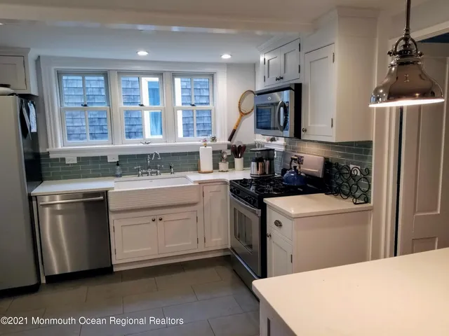 a kitchen with a sink stove and refrigerator