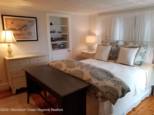 a bedroom with a bed and a table in it