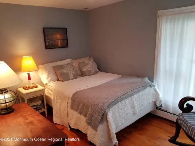 a bedroom with a bed and a lamp