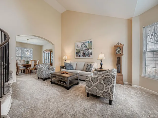 a living room with furniture flowerpot and window