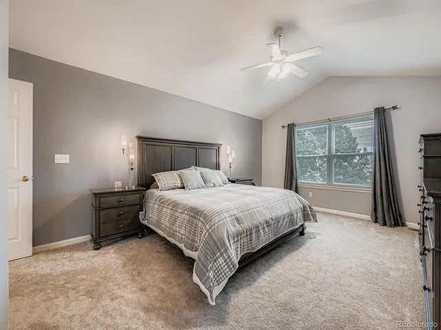 a bedroom with a large bed and a large window