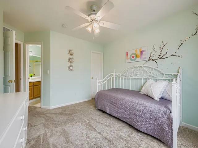 a living room with a bed and a chandelier