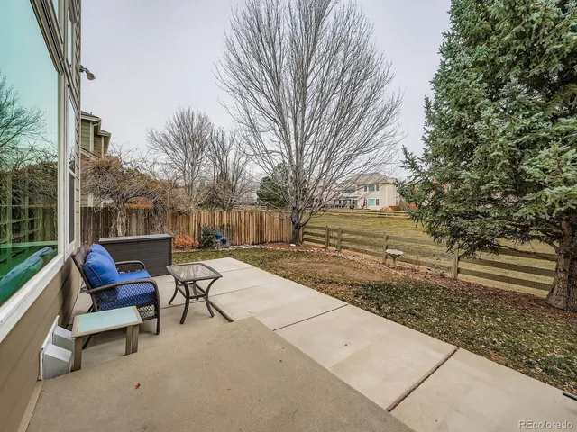 a view of backyard with seating area and trees