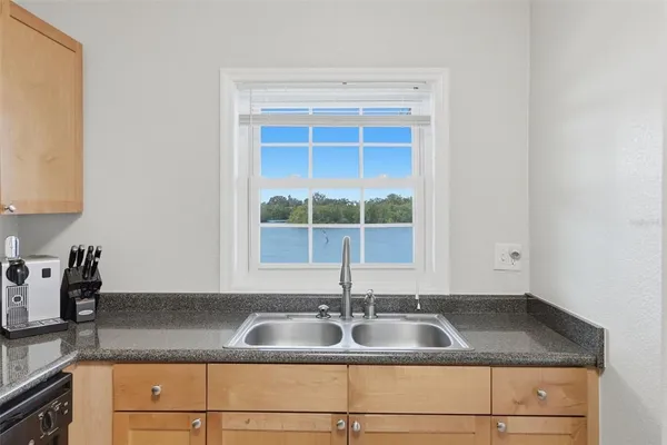a kitchen with granite countertop a sink and a window