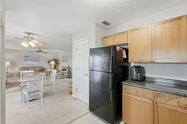 a kitchen with stainless steel appliances a refrigerator and cabinets