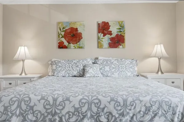 a bedroom with a bed and lamp