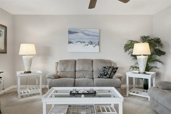 a living room with furniture and a lamp