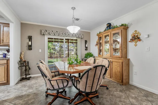 a dining room with furniture a chandelier and window