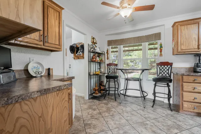 a kitchen with stainless steel appliances granite countertop a sink a stove and a wooden cabinets