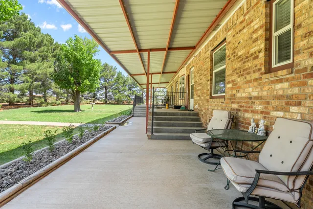 a view of a chairs in backyard of house