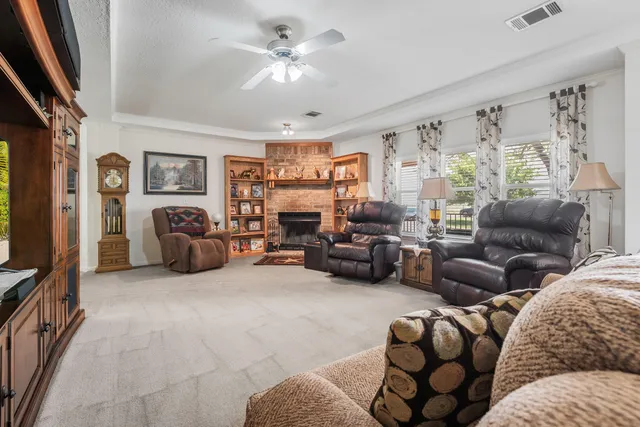 a living room with furniture ceiling fan and a window