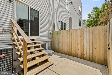 a view of a balcony with wooden floor and fence