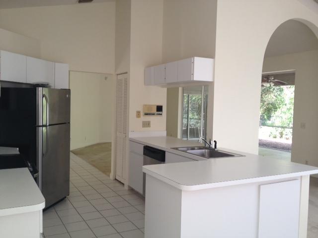 114 Colony Way East Jupiter, FL 33458 - Photo 4 of 7 a kitchen with stainless steel appliances a sink and a refrigerator
