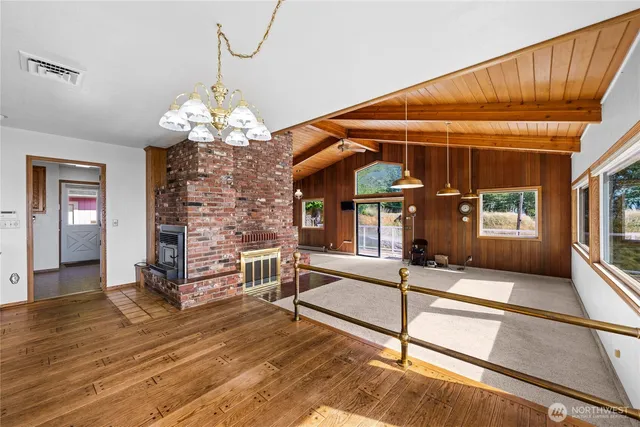 a view of a room with wooden floor and windows