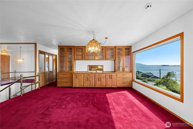 a living room with kitchen view and wooden floor