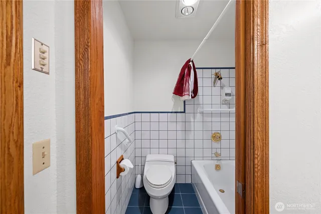 a bathroom with a toilet and a shower curtain