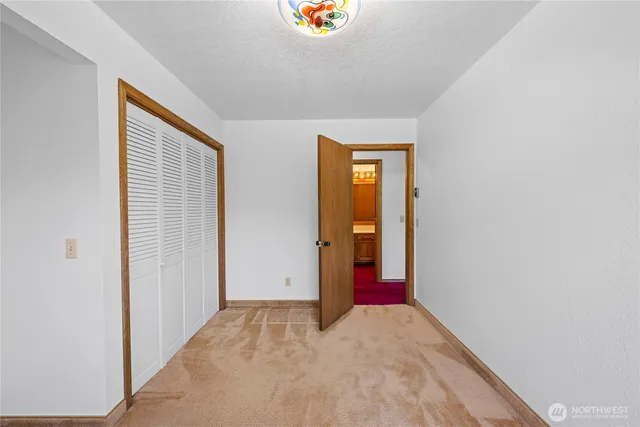 a view of an empty room and closet